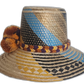 Boho chick straw hat crafted by Wayuu hands, showcasing intricate geometric weaving and bold color contrasts.