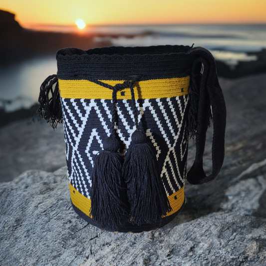 "Colorful handmade Wayuu crochet bag crafted by artisans, featuring vibrant patterns and a versatile boho design."
