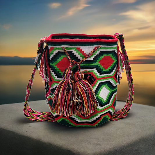 "Colorful handmade Wayuu crochet bag with adjustable strap for shoulder or crossbody wear, showcasing unique boho patterns."