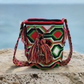 "Colorful handmade Wayuu crochet bag with adjustable strap for shoulder or crossbody wear, showcasing unique boho patterns."