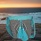 "Colorful handmade Wayuu crochet bag with geometric designs, crafted by indigenous artisans, adjustable strap for versatile w