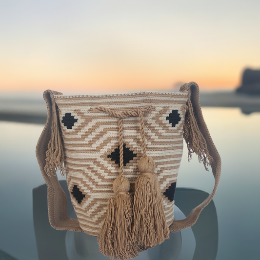 "Colorful handmade Wayuu crochet bag with geometric patterns, showcasing bohemian style and cultural craftsmanship."