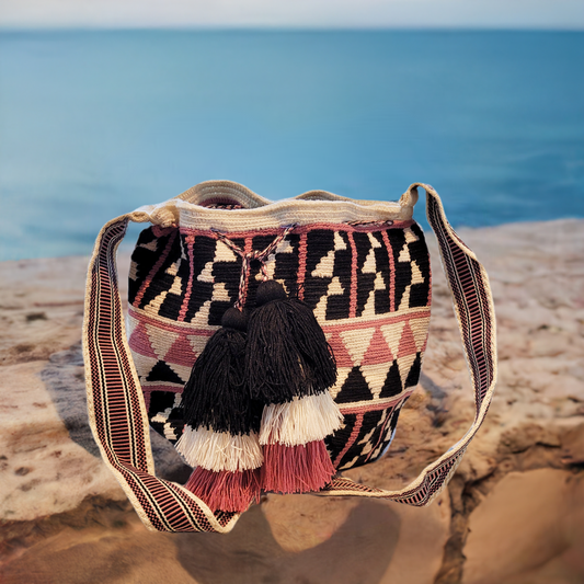 "Colorful handmade Wayuu crochet bag with geometric patterns and long, artisan-crafted straps for versatile wear."