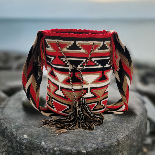 "Colorful handmade Wayuu crochet bag with intricate geometric patterns and adjustable strap, showcasing traditional Colombian