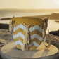 "Colorful handmade Wayuu crochet bag with intricate patterns and a long strap, showcasing traditional craftsmanship."