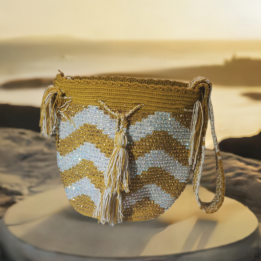 "Colorful handmade Wayuu crochet bag with intricate patterns and a long strap, showcasing traditional craftsmanship."