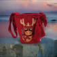 "Colorful handmade Wayuu crochet bag with vibrant bohemian designs, showcasing artisan craftsmanship and ethical fashion."