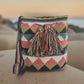 Handmade Wayuu crochet bag with colorful diamond patterns and tassels — a bold artisan piece for boho-chic everyday wear.