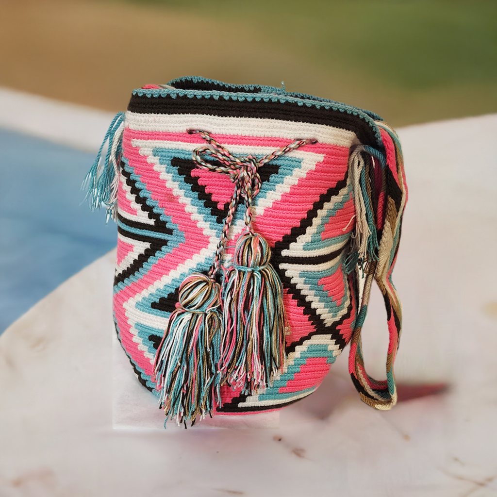 "Colorful handmade Wayuu crochet crossbody bag, showcasing traditional vibrant patterns and a boho flair, perfect for versati