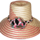 "Colorful handmade Wayuu hat by Wuitusu artisans, adorned with significant cultural pompoms, crafted from Iraca palm fibers."