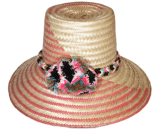 "Colorful handmade Wayuu hat by Wuitusu artisans, adorned with significant cultural pompoms, crafted from Iraca palm fibers."