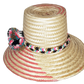 "Colorful handmade Wayuu hat by Wuitusu artisans, adorned with significant cultural pompoms, crafted from Iraca palm fibers."