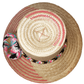 "Colorful handmade Wayuu hat by Wuitusu artisans, adorned with significant cultural pompoms, crafted from Iraca palm fibers."