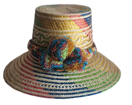 "Colorful handmade Wayuu hat by Wuitusu, crafted from Iraca palm fibers, adorned with culturally significant pompoms."