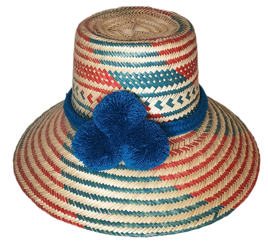 "Colorful handmade Wayuu hat by Wuitusu, crafted from Iraca palm fibers with unique pompoms, offering flexible wear styles."
