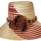 "Colorful Handmade Wayuu Hat by Wuitusu, crafted from Iraca palm fibers, featuring adjustable fit and decorative pompoms."