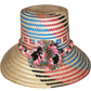 "Colorful handmade Wayuu hat crafted from Iraca palm, adorned with cultural pompoms, adjustable for a perfect fit."