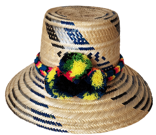 "Colorful handmade Wayuu hat crafted from Iraca palm, adorned with cultural pompoms for style and symbolism."