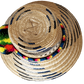 "Colorful handmade Wayuu hat crafted from Iraca palm, adorned with cultural pompoms for style and symbolism."