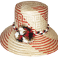 "Colorful handmade Wayuu hat crafted from Iraca palm, featuring decorative pompoms and adaptable fit, promoting Wayuu culture