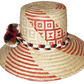 "Colorful handmade Wayuu hat crafted from Iraca palm, featuring decorative pompoms and adaptable fit, promoting Wayuu culture