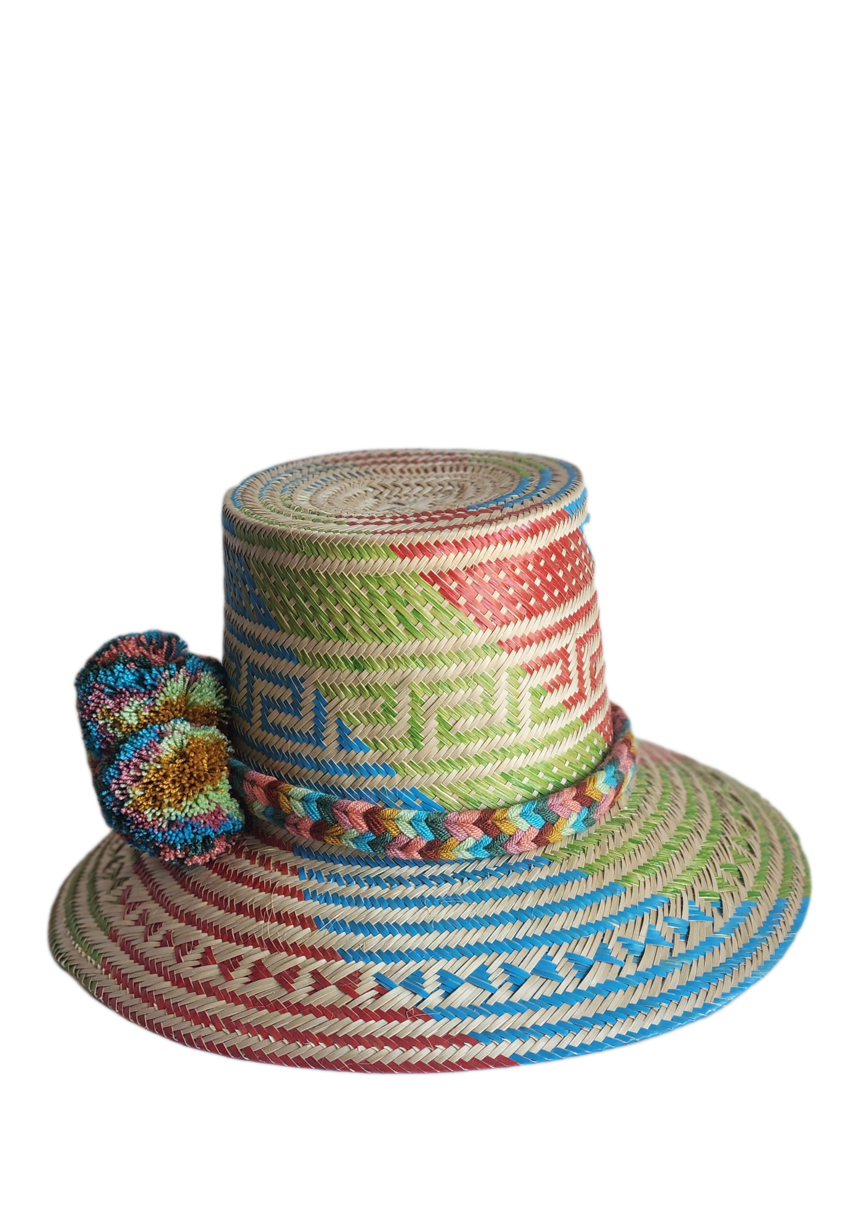 "Colorful handmade Wayuu hat crafted from Iraca palm, featuring adjustable size and cultural pompoms, supporting Wayuu artisa