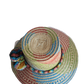 "Colorful handmade Wayuu hat crafted from Iraca palm, featuring adjustable size and cultural pompoms, supporting Wayuu artisa