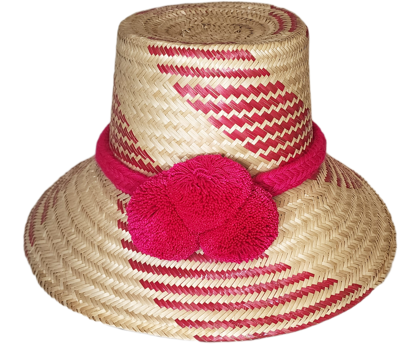 "Colorful handmade Wayuu hat crafted from Iraca palm fiber, adorned with significant pompoms, from Colombia and Venezuela."