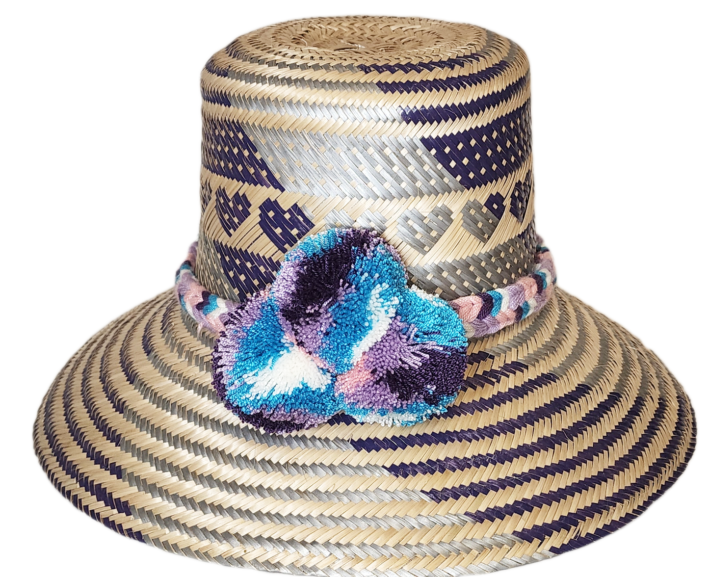 "Colorful handmade Wayuu hat crafted from Iraca palm fibers, adorned with meaningful pompoms, offering unique style and sun p