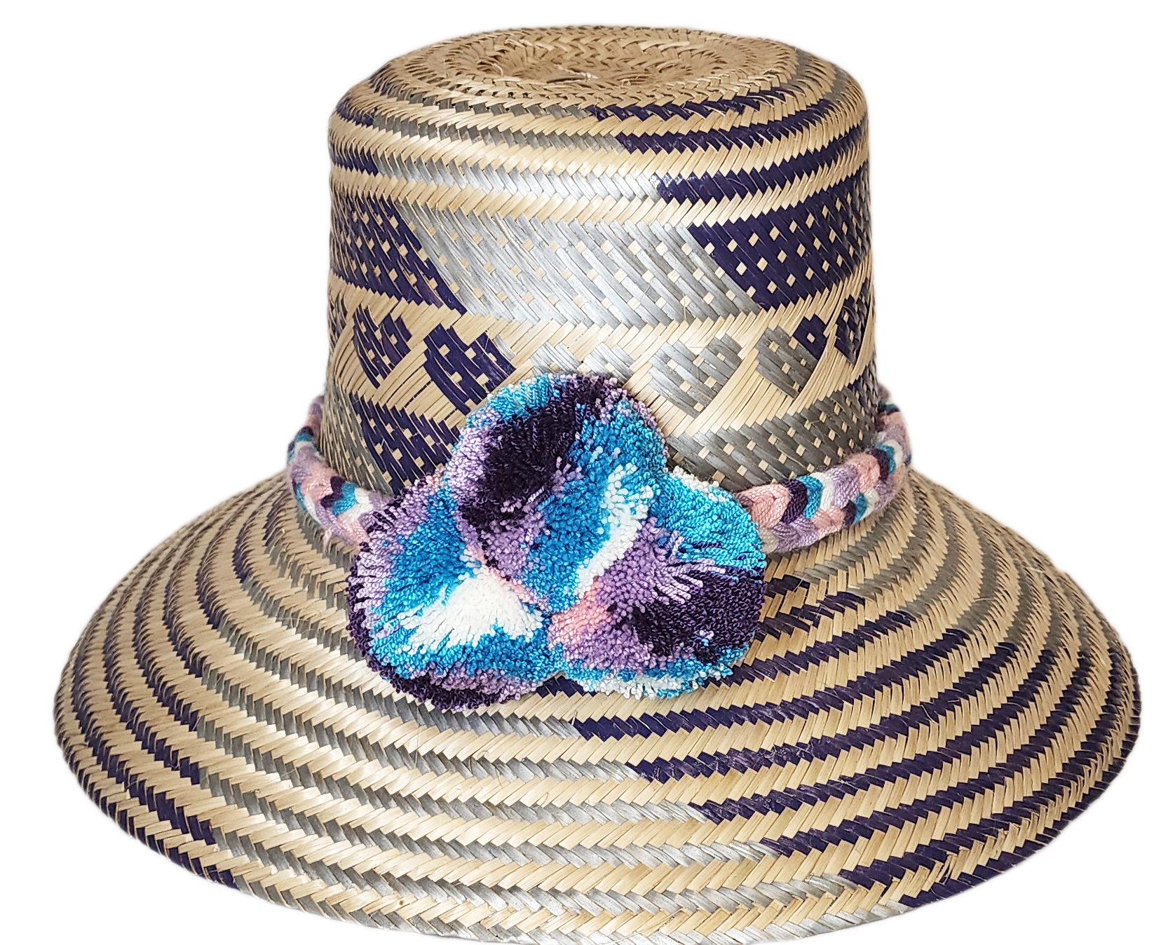"Colorful handmade Wayuu hat crafted from Iraca palm fibers, adorned with meaningful pompoms, offering unique style and sun p