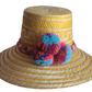 "Colorful handmade Wayuu hat crafted from Iraca palm fibers, adorned with significant pompoms, showcasing artisan craftsmansh