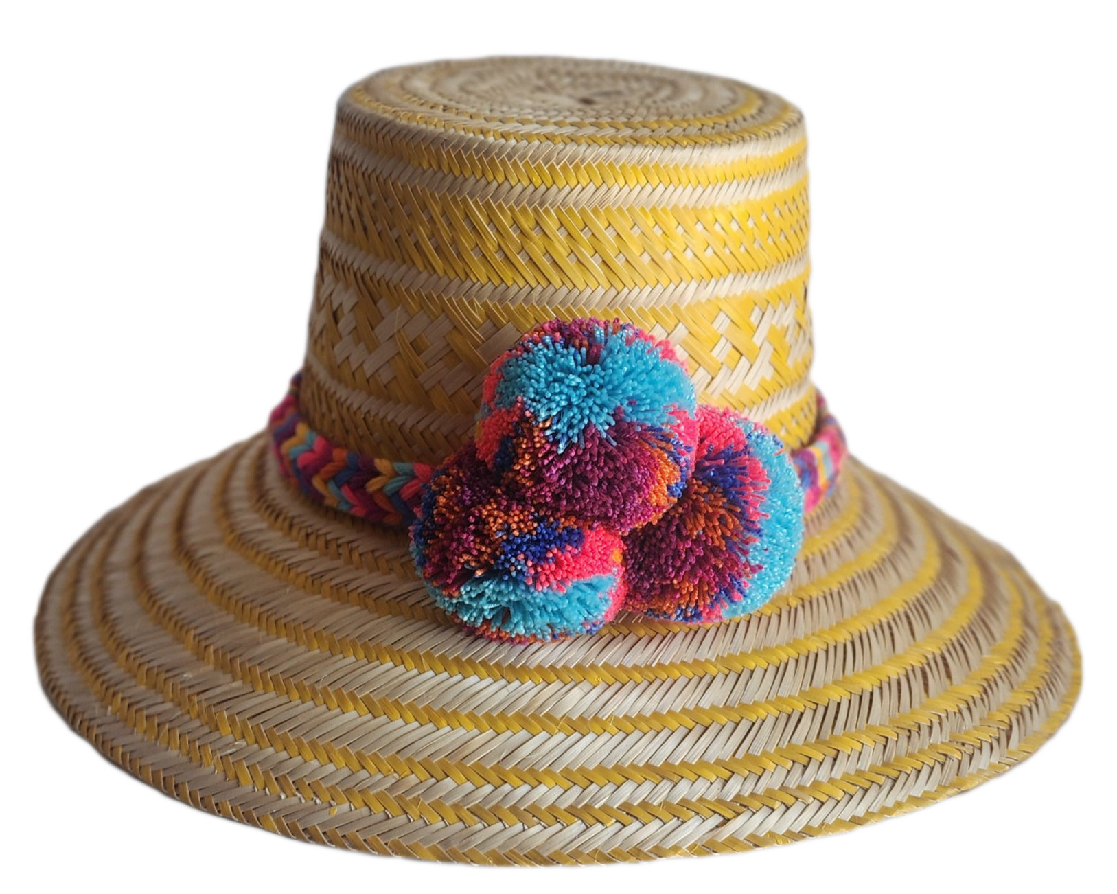 "Colorful handmade Wayuu hat crafted from Iraca palm fibers, adorned with significant pompoms, showcasing artisan craftsmansh