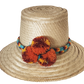 "Colorful handmade Wayuu hat crafted from Iraca palm fibers, adorned with culturally significant pompoms for style and prospe