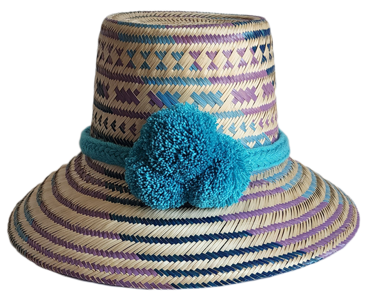 "Colorful handmade Wayuu hat crafted from Iraca palm fibers, adorned with meaningful pompoms, adjustable fit."