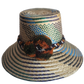 "Colorful handmade Wayuu hat crafted from Iraca palm fibers, adorned with culturally significant pompoms, offering adjustable