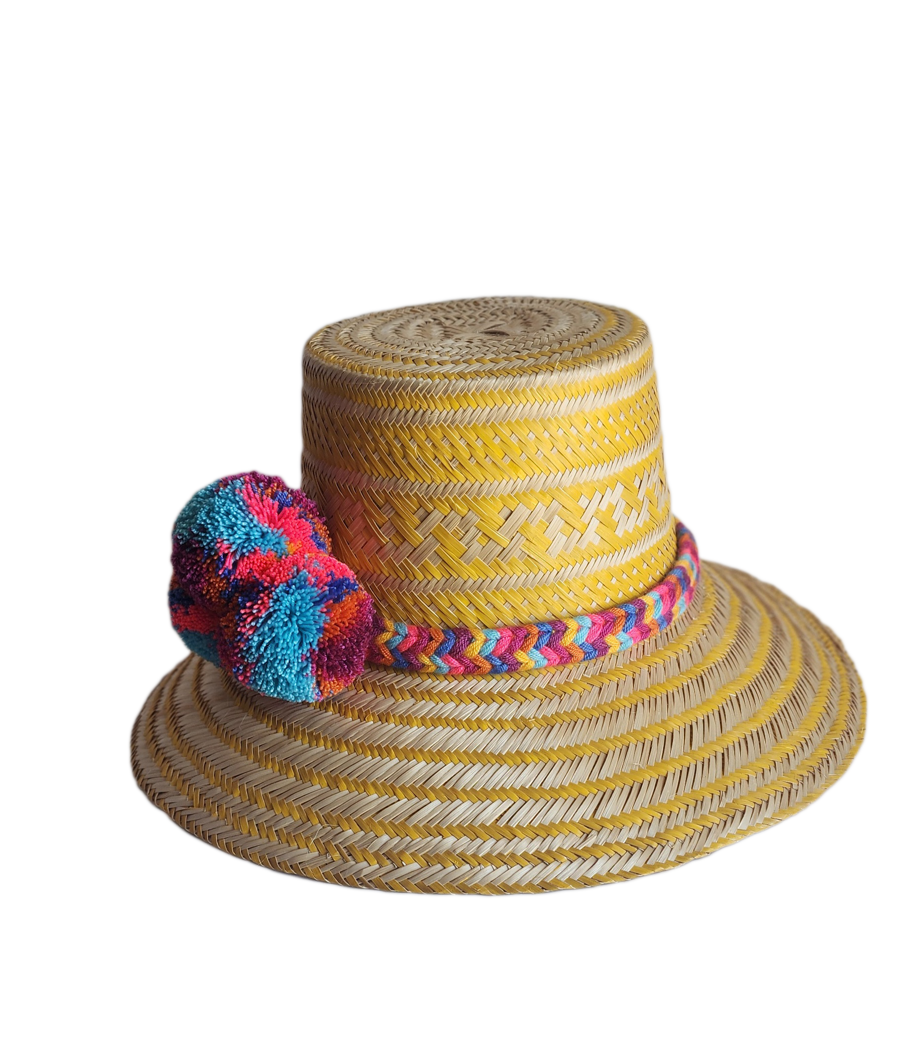 "Colorful handmade Wayuu hat crafted from Iraca palm fibers, adorned with significant pompoms, showcasing artisan craftsmansh