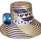 "Colorful handmade Wayuu hat crafted from Iraca palm fibers, adorned with meaningful pompoms, offering unique style and sun p