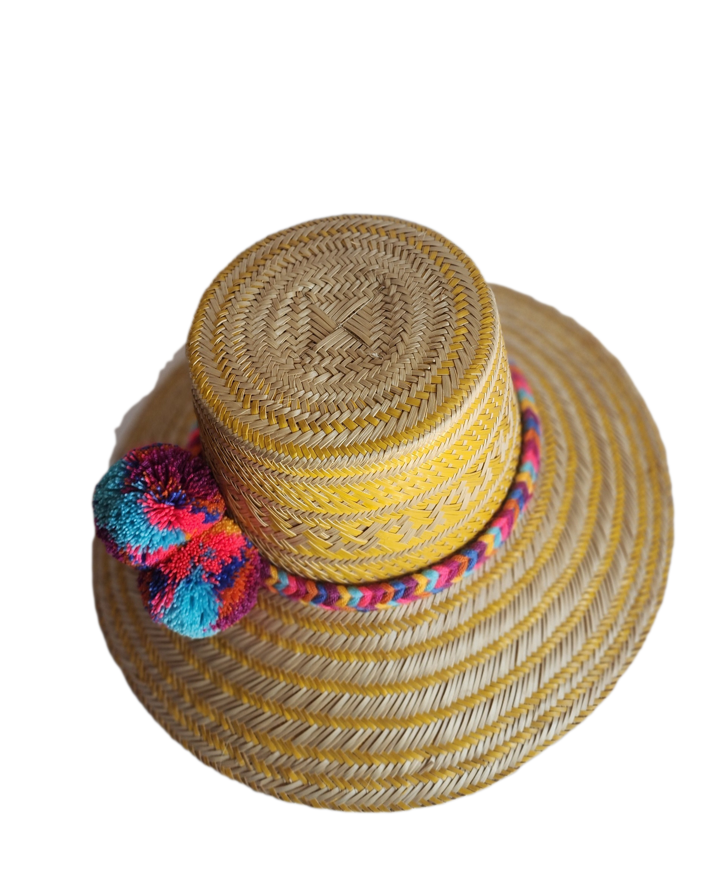 "Colorful handmade Wayuu hat crafted from Iraca palm fibers, adorned with significant pompoms, showcasing artisan craftsmansh