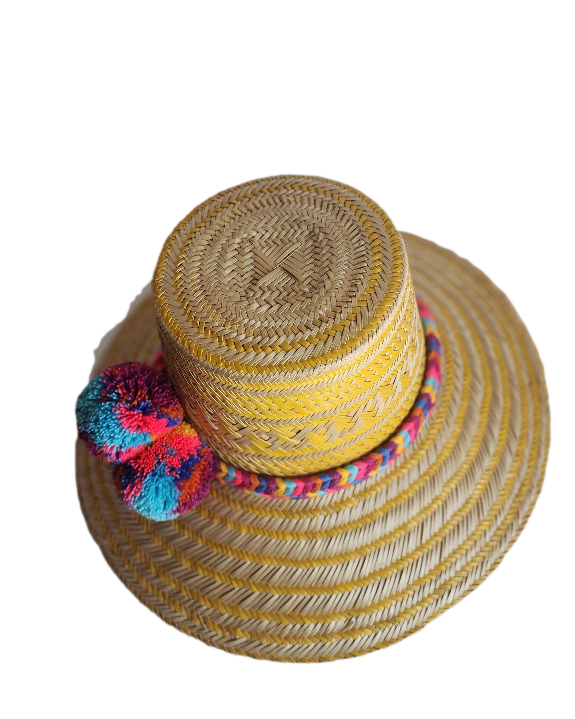 "Colorful handmade Wayuu hat crafted from Iraca palm fibers, adorned with significant pompoms, showcasing artisan craftsmansh