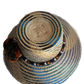 "Colorful handmade Wayuu hat crafted from Iraca palm fibers, adorned with culturally significant pompoms, offering adjustable