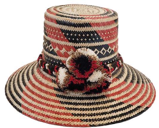 "Colorful handmade Wayuu hat crafted from Iraca palm fibers, featuring culturally significant pompoms for stylish sun protect