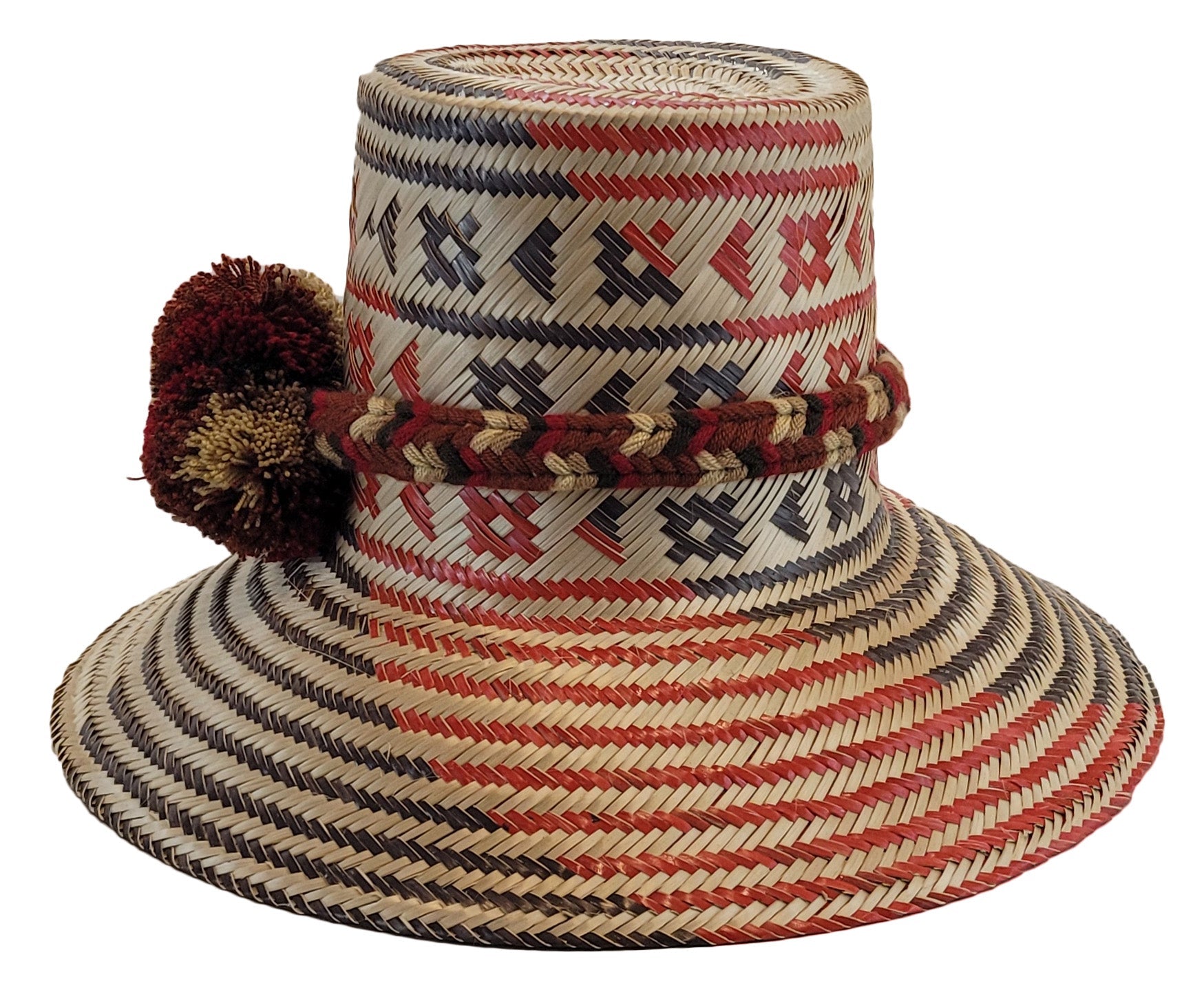 "Colorful handmade Wayuu hat crafted from iraca palm fibers, featuring a broad brim for sun protection and adjustable fit for