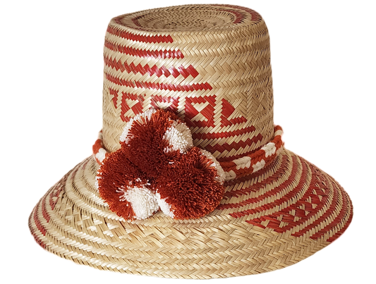 "Colorful handmade Wayuu hat crafted from Iraca palm fibers with significant cultural pompoms, offering versatile styling for