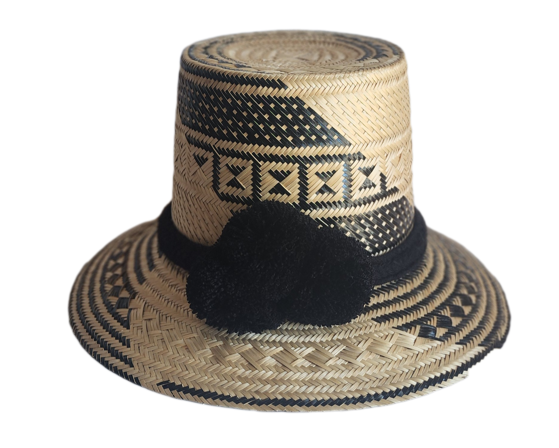 "Colorful handmade Wayuu hat crafted from Iraca palm fibers with culturally significant pompoms, offering sun protection and 
