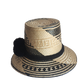 "Colorful handmade Wayuu hat crafted from Iraca palm fibers with culturally significant pompoms, offering sun protection and 