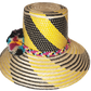 "Colorful handmade Wayuu hat crafted from Iraca palm fibers with decorative pompoms, showcasing vibrant Wayuu cultural design