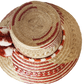 "Colorful handmade Wayuu hat crafted from Iraca palm fibers with significant cultural pompoms, offering versatile styling for