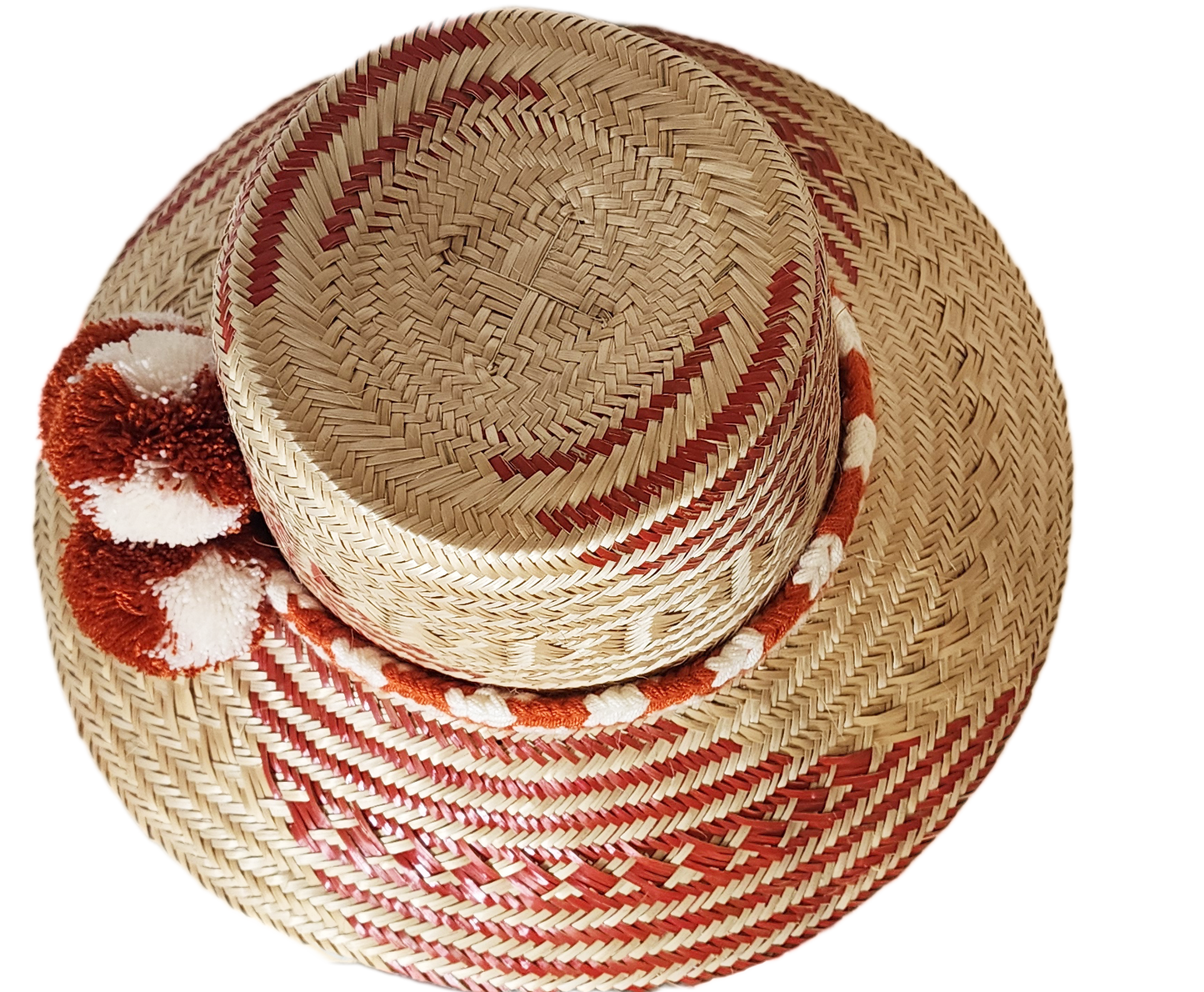 "Colorful handmade Wayuu hat crafted from Iraca palm fibers with significant cultural pompoms, offering versatile styling for