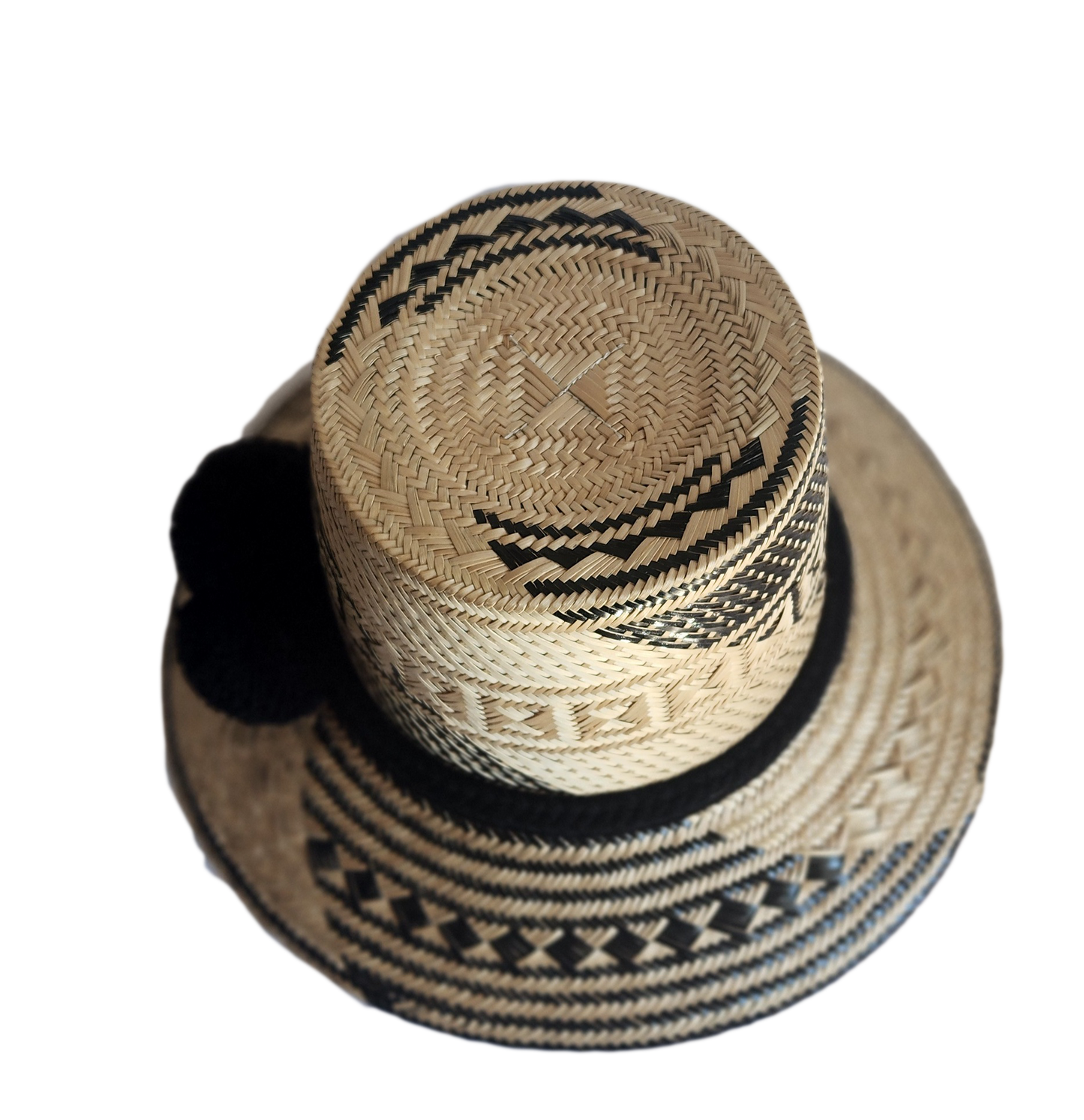 "Colorful handmade Wayuu hat crafted from Iraca palm fibers with culturally significant pompoms, offering sun protection and 
