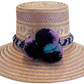 "Colorful handmade Wayuu hat from Iraca palm, adorned with cultural pompoms, adjustable for any head size, supports Wayuu chi